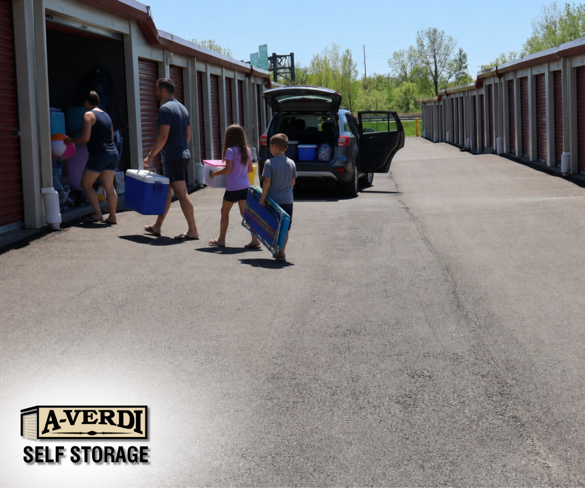 A family unloads summer items from a parked vehicle into an open self storage unit, including coolers, bins, and beach gear on a sunny day.